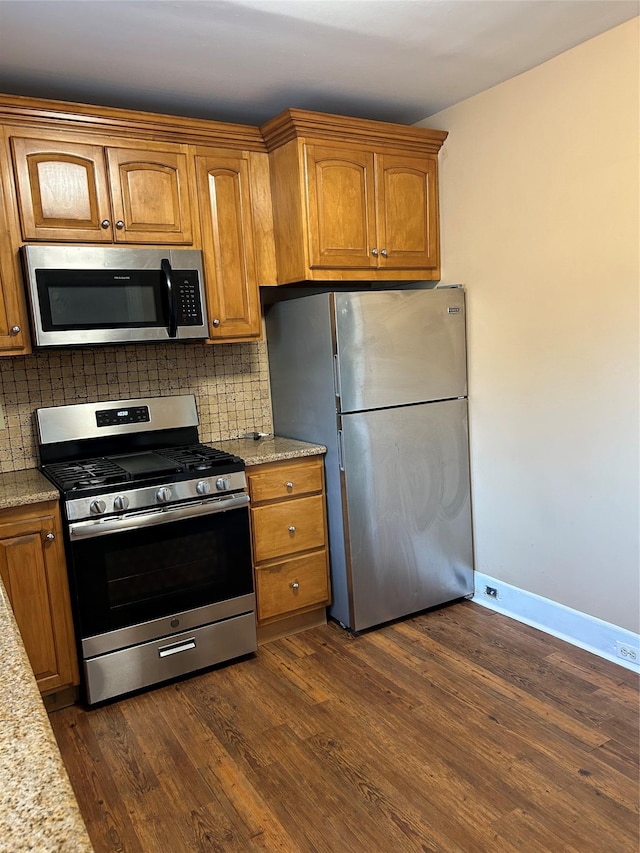 11 Fox Holw, Hillburn, NY 10931 - kitchen featuring stainless steel appliances, tasteful backsplash, brown cabinetry, and dark wood-type flooring