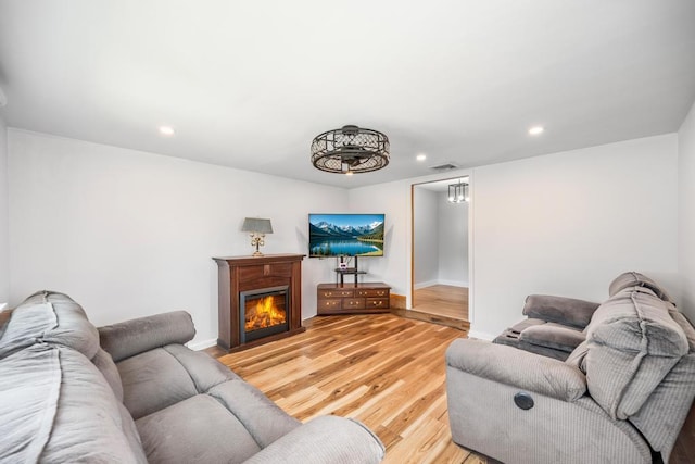 220 Farhan Ln, North Babylon, NY 11703 - living room with light wood finished floors, recessed lighting, baseboards, and a warm lit fireplace