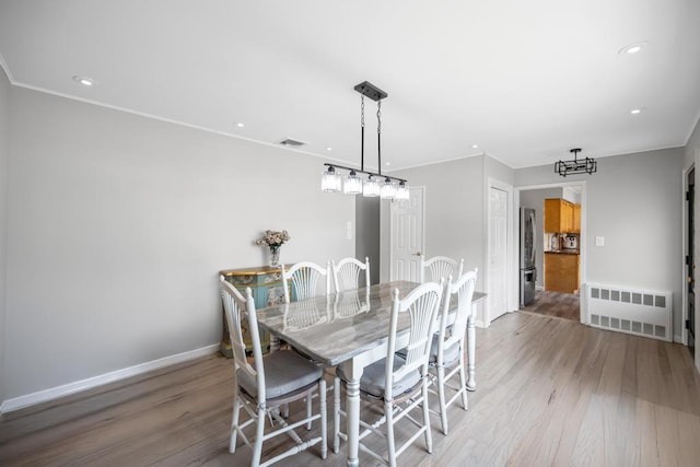 220 Farhan Ln, North Babylon, NY 11703 - dining space with radiator heating unit, light wood-style flooring, baseboards, recessed lighting, and crown molding