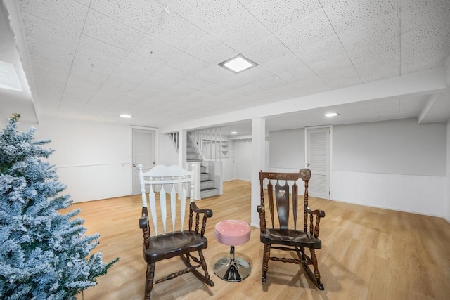 220 Farhan Ln, North Babylon, NY 11703 - living area with stairway, wood finished floors, and a wainscoted wall