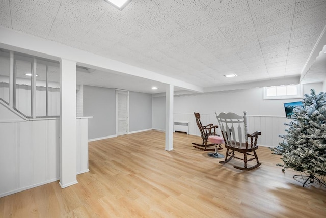 220 Farhan Ln, North Babylon, NY 11703 - living area featuring radiator heating unit, wood finished floors, and baseboards