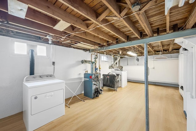 220 Farhan Ln, North Babylon, NY 11703 - basement featuring washer / clothes dryer, a heating unit, and wood finished floors