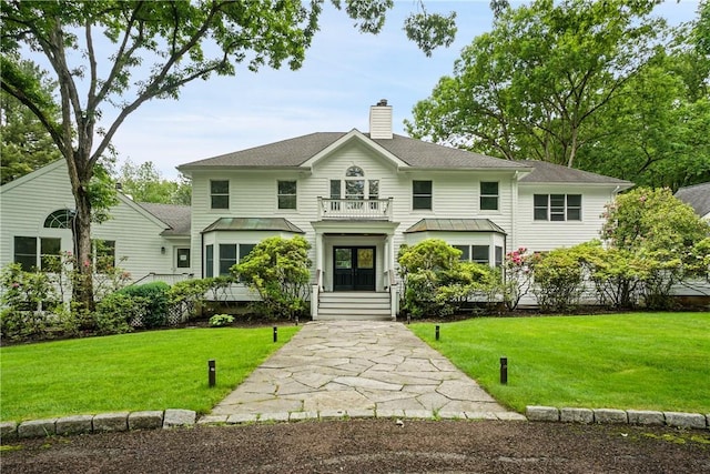 792-820 Old Post Rd, Bedford, NY 10506 - view of front facade featuring a balcony, a chimney, french doors, and a front yard