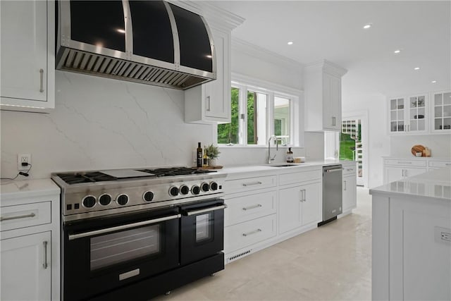 792-820 Old Post Rd, Bedford, NY 10506 - kitchen with range with two ovens, a sink, stainless steel dishwasher, tasteful backsplash, and white cabinetry