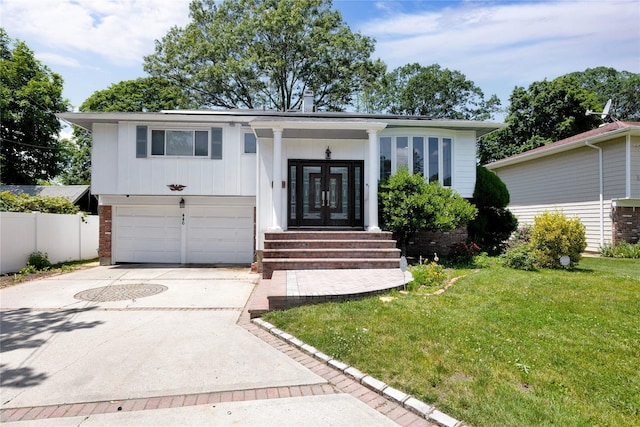 446 Joan Ct, West Hempstead, NY 11552 - view of front of house with an attached garage, driveway, and french doors