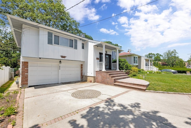 446 Joan Ct, West Hempstead, NY 11552 - split level home featuring a garage, concrete driveway, board and batten siding, and brick siding