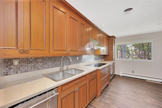 446 Joan Ct, West Hempstead, NY 11552 - kitchen featuring under cabinet range hood, dishwasher, black electric cooktop, brown cabinets, and recessed lighting