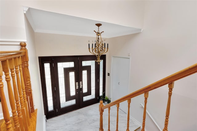 446 Joan Ct, West Hempstead, NY 11552 - foyer entrance with a chandelier, light marble finish flooring, crown molding, and stairs