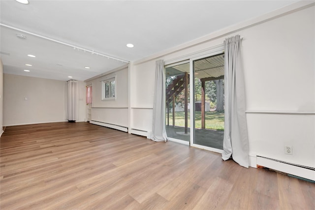 446 Joan Ct, West Hempstead, NY 11552 - empty room featuring light wood-style floors, plenty of natural light, a baseboard heating unit, and recessed lighting