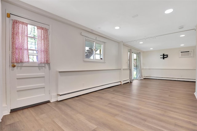 446 Joan Ct, West Hempstead, NY 11552 - unfurnished room with a baseboard radiator, baseboard heating, light wood-style floors, recessed lighting, and an AC wall unit