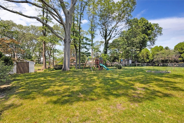446 Joan Ct, West Hempstead, NY 11552 - view of yard featuring a storage unit and a playground