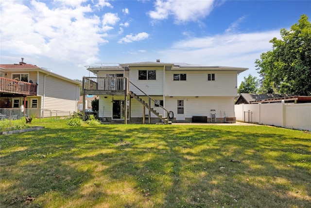 446 Joan Ct, West Hempstead, NY 11552 - back of house with solar panels, stairway, a fenced backyard, a patio, and a deck