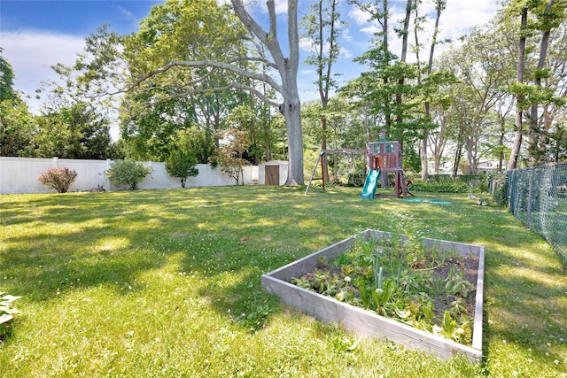 446 Joan Ct, West Hempstead, NY 11552 - fenced backyard with a shed, a playground, and a vegetable garden