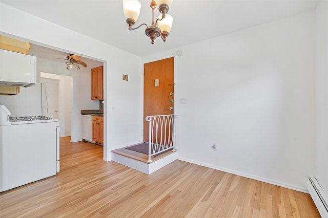 12 Normandy Vlg Unit 2, Nanuet, NY 10954 - unfurnished dining area featuring a baseboard radiator, light wood finished floors, a chandelier, ceiling fan, and baseboards