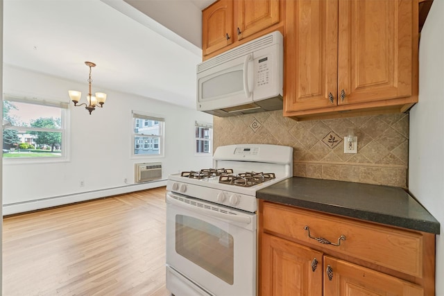 12 Normandy Vlg Unit 2, Nanuet, NY 10954 - kitchen featuring white appliances, a baseboard heating unit, dark countertops, a chandelier, and backsplash