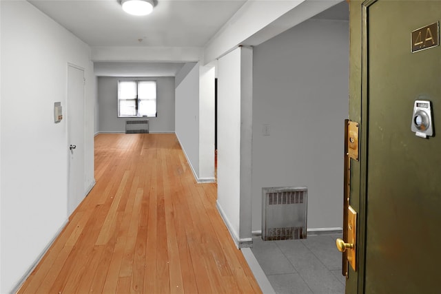 2105 Wallace Ave Unit 4A, Bronx, NY 10462 - hallway featuring radiator heating unit, light wood-type flooring, and heating unit