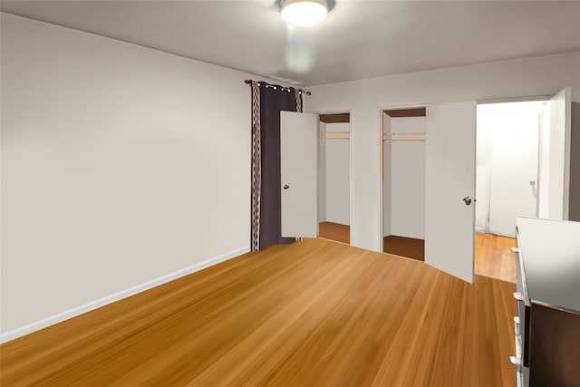 2105 Wallace Ave Unit 4A, Bronx, NY 10462 - unfurnished bedroom with multiple closets and wood finished floors