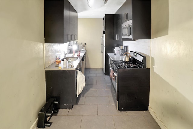 2105 Wallace Ave Unit 4A, Bronx, NY 10462 - kitchen featuring appliances with stainless steel finishes, backsplash, dark cabinets, light tile patterned flooring, and light countertops