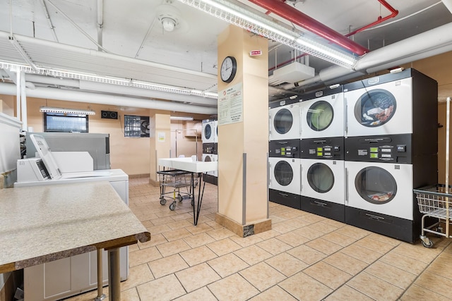 61-15 97th St Unit 8M, Rego Park, NY 11374 - shared laundry with estacked washer and dryer, independent washer and dryer, and light tile patterned floors