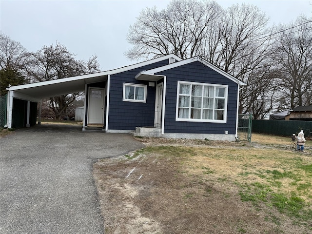 1251 Udall Rd, Bay Shore, NY 11706 - view of front facade featuring driveway and an attached carport