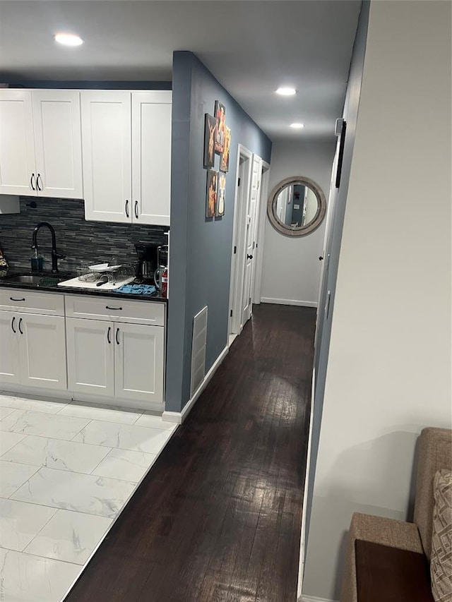 1251 Udall Rd, Bay Shore, NY 11706 - kitchen with dark countertops, a sink, white cabinetry, backsplash, and recessed lighting