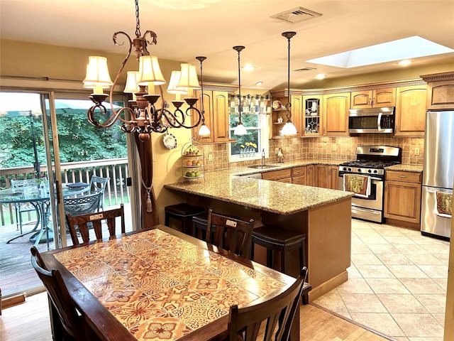 7 S Van Dyke Ave, Airmont, NY 10901 - kitchen with stainless steel appliances, a sink, a peninsula, plenty of natural light, and recessed lighting