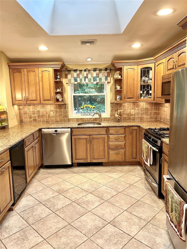 7 S Van Dyke Ave, Airmont, NY 10901 - kitchen with appliances with stainless steel finishes, open shelves, brown cabinets, wine cooler, and recessed lighting