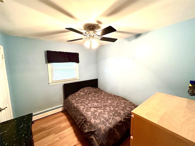 7 S Van Dyke Ave, Airmont, NY 10901 - bedroom featuring a baseboard heating unit, wood finished floors, and a ceiling fan