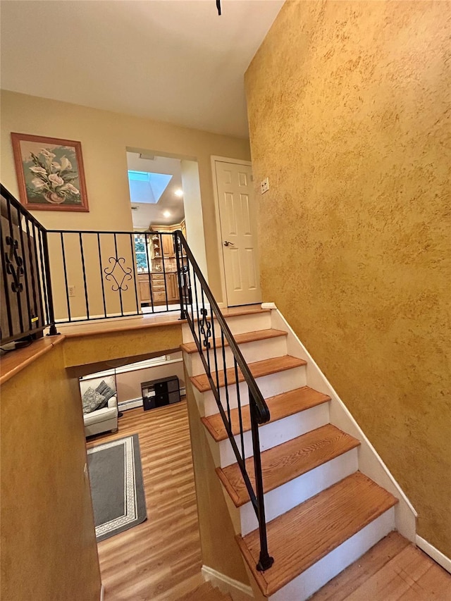 7 S Van Dyke Ave, Airmont, NY 10901 - staircase with wood finished floors, baseboards, and a skylight