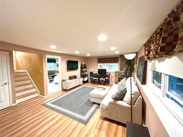 7 S Van Dyke Ave, Airmont, NY 10901 - living room featuring wood finished floors, recessed lighting, stairs, and a wood stove