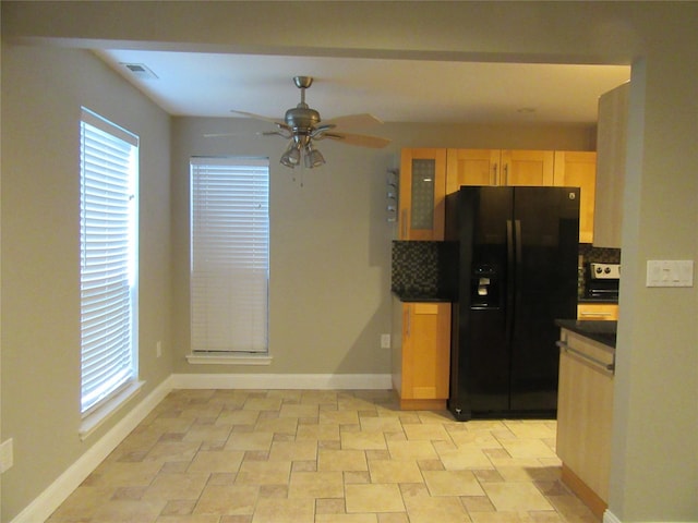 1 Brook Dr Unit 13, Washingtonville, NY 10992 - kitchen with black fridge with ice dispenser, a ceiling fan, glass insert cabinets, dark countertops, and light brown cabinets