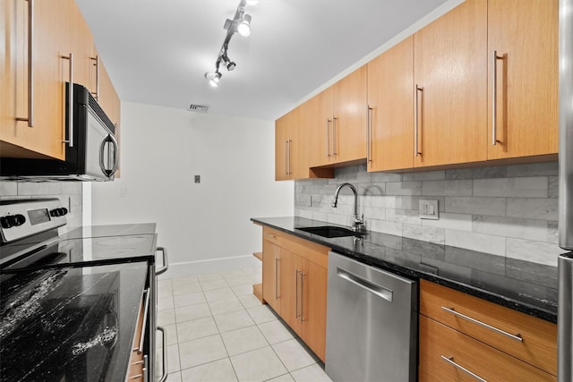 341 Furnace Dock Rd Unit 30, Cortlandt Manor, NY 10567 - kitchen featuring appliances with stainless steel finishes, dark stone countertops, light tile patterned floors, and backsplash