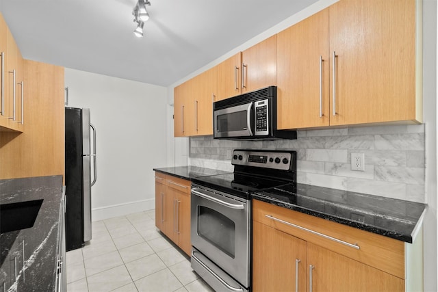 341 Furnace Dock Rd Unit 30, Cortlandt Manor, NY 10567 - kitchen featuring stainless steel appliances, light tile patterned floors, dark stone countertops, decorative backsplash, and rail lighting