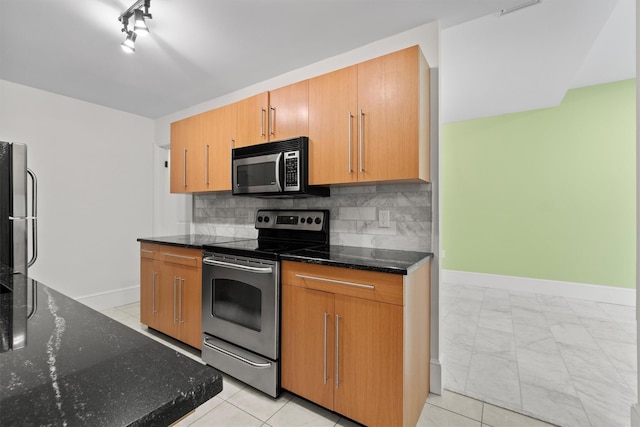 341 Furnace Dock Rd Unit 30, Cortlandt Manor, NY 10567 - kitchen with stainless steel appliances, dark stone counters, backsplash, and brown cabinetry