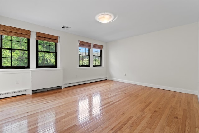 341 Furnace Dock Rd Unit 30, Cortlandt Manor, NY 10567 - empty room featuring a baseboard heating unit and light wood-style floors