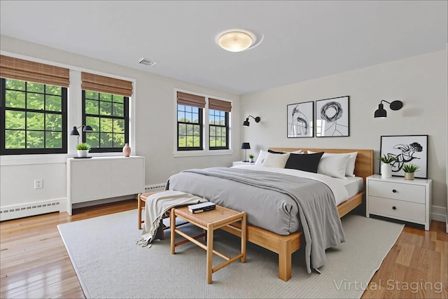341 Furnace Dock Rd Unit 30, Cortlandt Manor, NY 10567 - bedroom with baseboard heating and wood finished floors