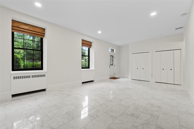 341 Furnace Dock Rd Unit 30, Cortlandt Manor, NY 10567 - spare room featuring radiator heating unit, light marble finish floors, and recessed lighting