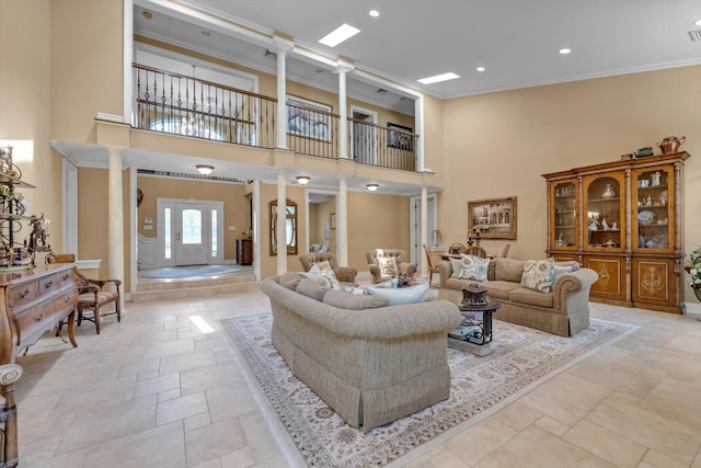 251 Wilmot Dr, Hewlett, NY 11557 - living room featuring ornate columns, stone tile flooring, ornamental molding, a towering ceiling, and recessed lighting