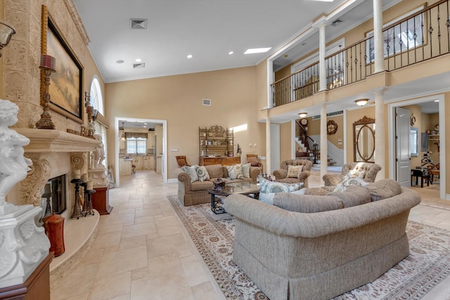 251 Wilmot Dr, Hewlett, NY 11557 - living area with a high ceiling, ornate columns, crown molding, stone tile flooring, and a premium fireplace