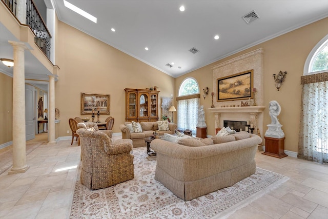 251 Wilmot Dr, Hewlett, NY 11557 - living room featuring decorative columns, stone tile floors, plenty of natural light, high vaulted ceiling, and ornamental molding