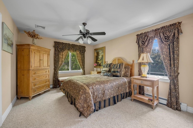 251 Wilmot Dr, Hewlett, NY 11557 - bedroom featuring light carpet, baseboards, a ceiling fan, and a baseboard radiator