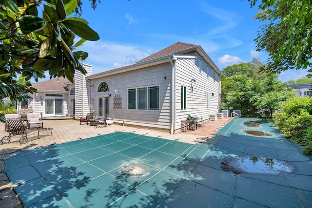 251 Wilmot Dr, Hewlett, NY 11557 - back of property featuring a patio area and a covered pool