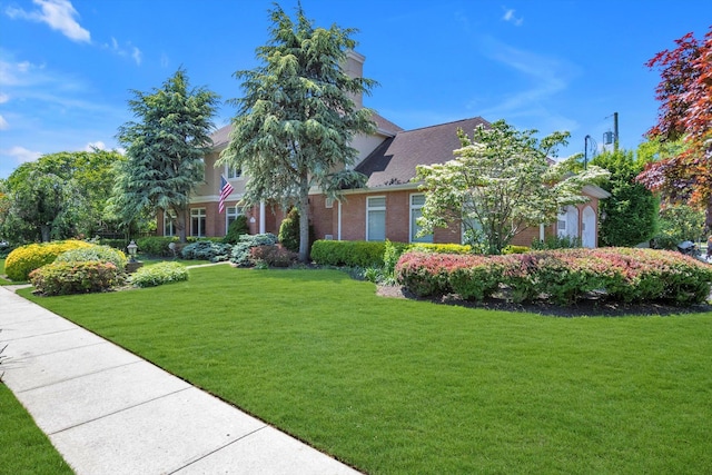 251 Wilmot Dr, Hewlett, NY 11557 - obstructed view of property with a front lawn and brick siding