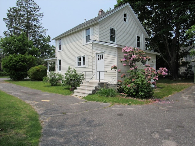506 Raynor Ave, Riverhead, NY 11901 - view of front of house with a chimney