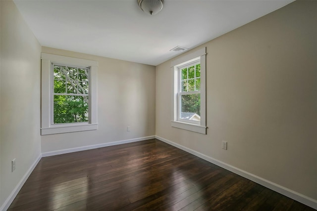 506 Raynor Ave, Riverhead, NY 11901 - spare room featuring dark wood-type flooring and baseboards
