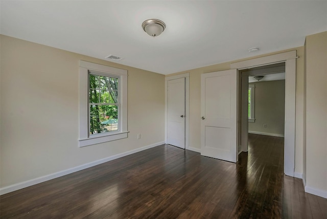 506 Raynor Ave, Riverhead, NY 11901 - unfurnished bedroom with dark wood-style flooring and baseboards
