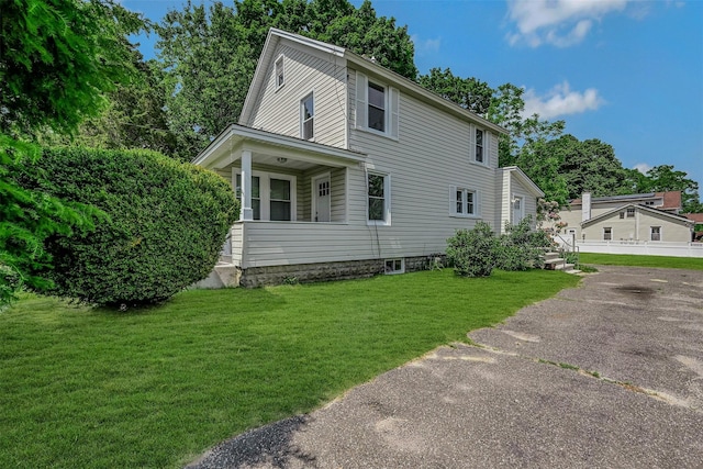 506 Raynor Ave, Riverhead, NY 11901 - view of front of home with a front yard, driveway, and a porch