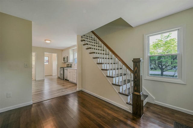 506 Raynor Ave, Riverhead, NY 11901 - staircase with baseboards, plenty of natural light, and wood finished floors