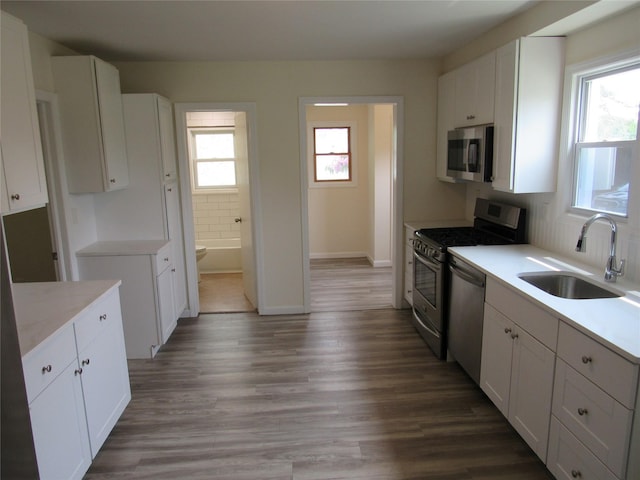 506 Raynor Ave, Riverhead, NY 11901 - kitchen with stainless steel appliances, a sink, and white cabinetry