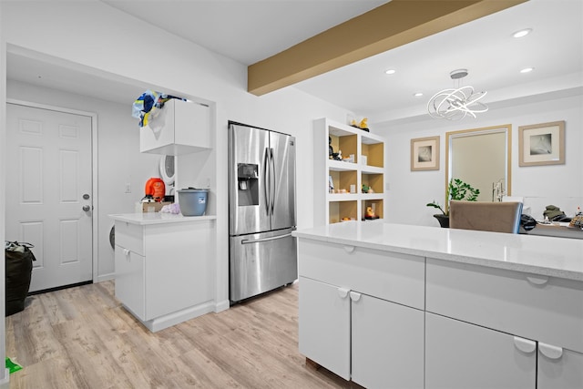 31 Forestburgh Rd, Monticello, NY 12701 - kitchen featuring stainless steel refrigerator with ice dispenser, white cabinetry, light wood-type flooring, recessed lighting, and a chandelier